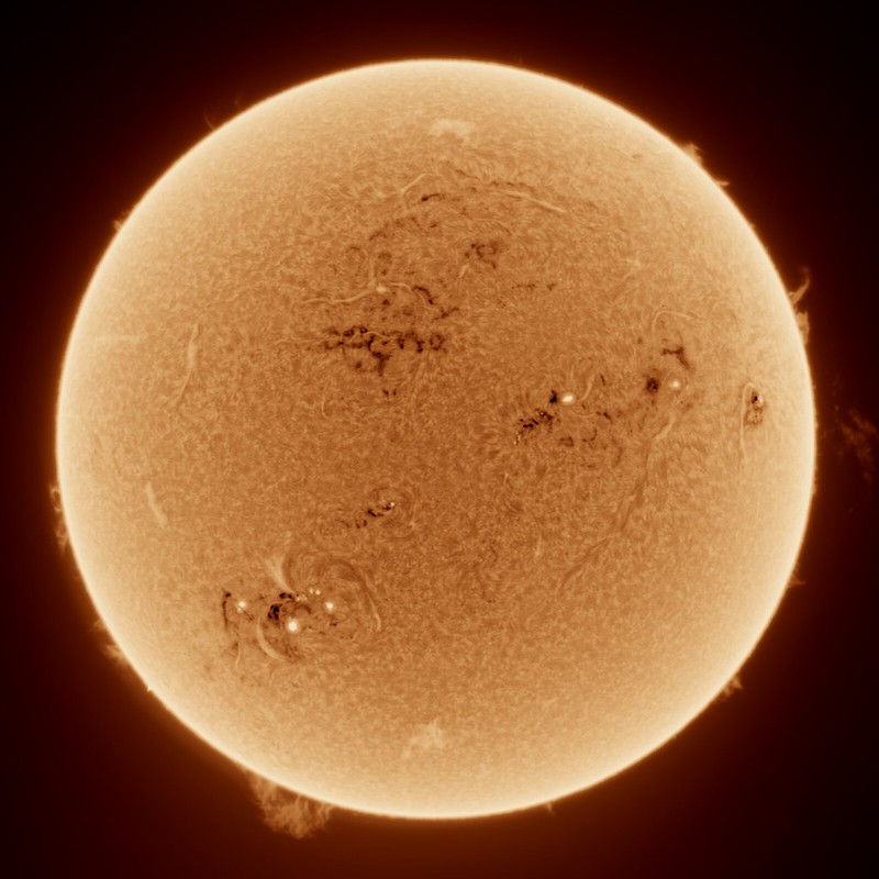 a picture of the sun, exposing turbulances and dark spots on the surface.